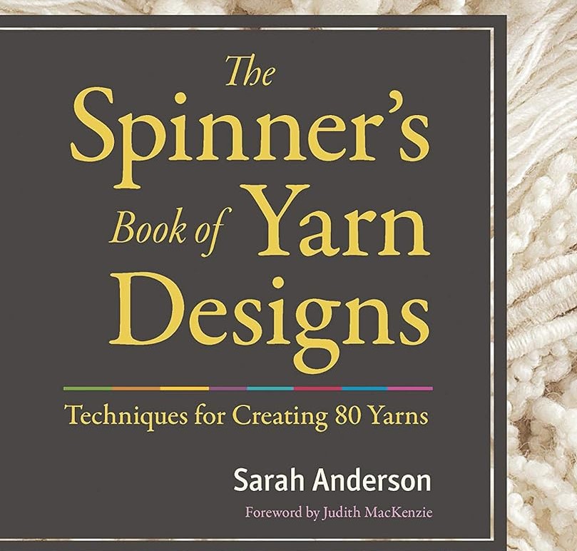 Photo of part of book cover with the text "The Spinner's Book of Yarn Designs"