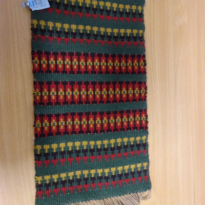 Wall hanging in Krokbrad pattern in colours of green, red, yellow and black