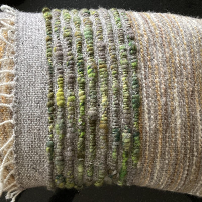 A blue, green and pale-brown cushion