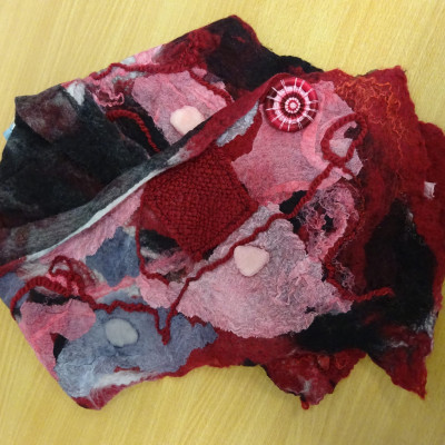 A felted cowl in various shades of red