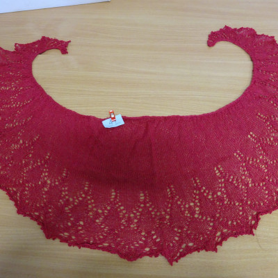 Red shawl, crescent-shaped.