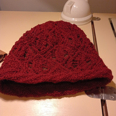 A lacy red knitted hat