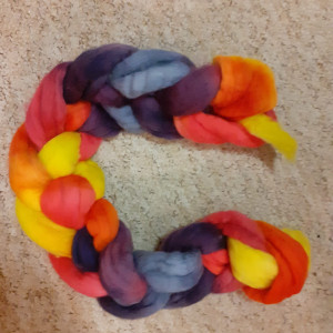 A multi-coloured hank of dyed fiber.