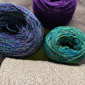 Balls of yarn in purple, green and blues.
